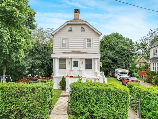 7 Wellesley Ave, Yonkers, NY 10705 - view of front of home featuring a gate, a chimney, and a fenced front yard