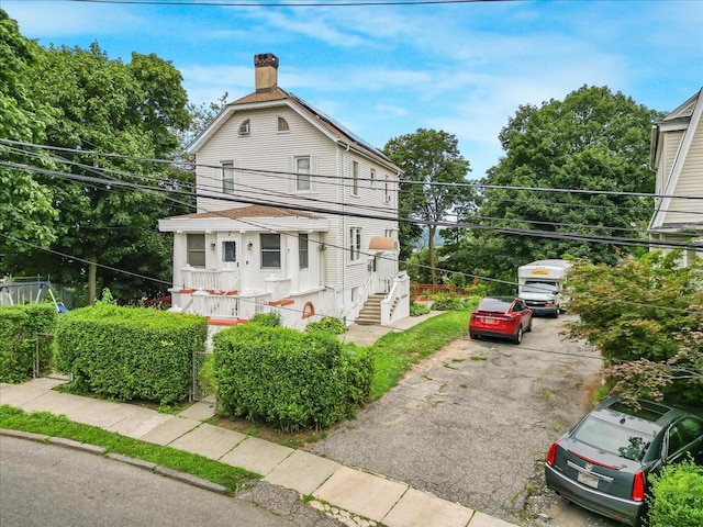 7 Wellesley Ave, Yonkers, NY 10705 - view of property exterior featuring asphalt driveway and a chimney