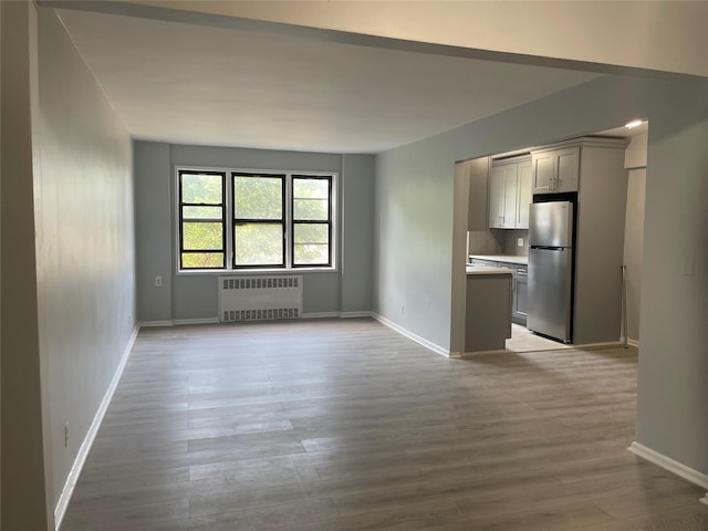 2 Fisher Dr Unit 307, Mount Vernon, NY 10552 - unfurnished living room featuring radiator and wood finished floors