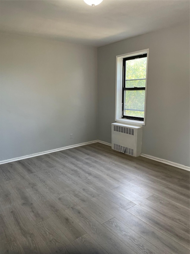 2 Fisher Dr Unit 307, Mount Vernon, NY 10552 - unfurnished room with radiator and dark wood finished floors