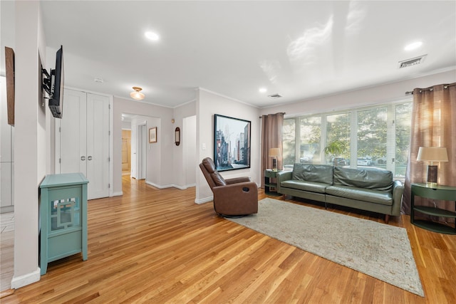 1942 Lilac Dr, Westbury, NY 11590 - living room with crown molding, light wood finished floors, and recessed lighting