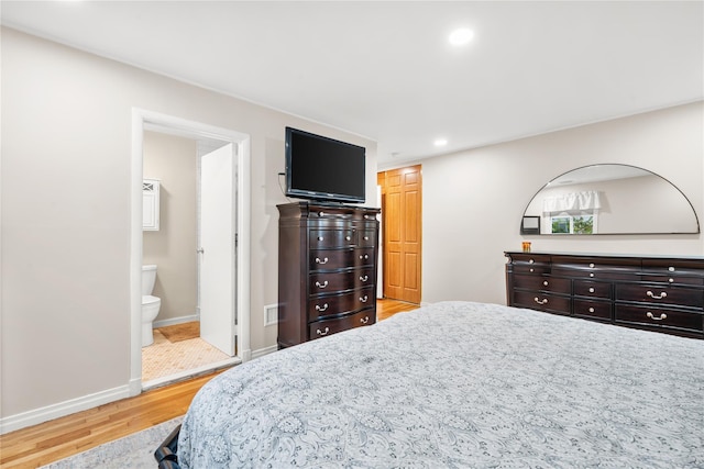 1942 Lilac Dr, Westbury, NY 11590 - bedroom featuring light wood finished floors, recessed lighting, and ensuite bath