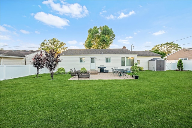 1942 Lilac Dr, Westbury, NY 11590 - rear view of property featuring a fenced backyard, a storage shed, and a patio area