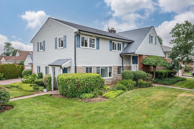 1901 New Hyde Park Rd, New Hyde Park, NY 11040 - view of front of home with a front yard, a chimney, and stone siding