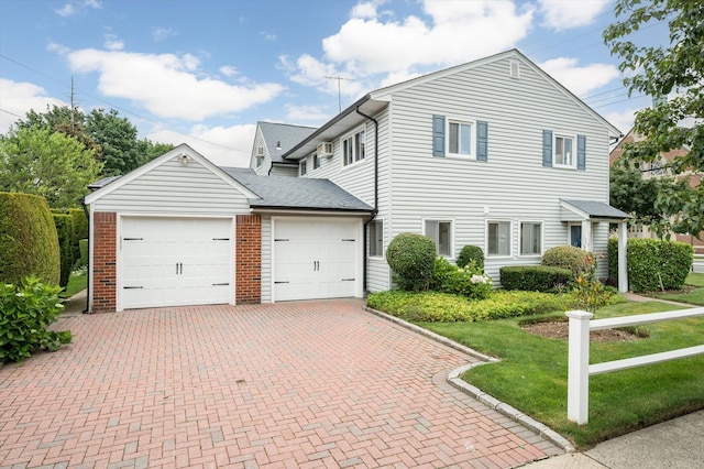 1901 New Hyde Park Rd, New Hyde Park, NY 11040 - traditional-style house featuring decorative driveway, an attached garage, a front yard, and roof with shingles