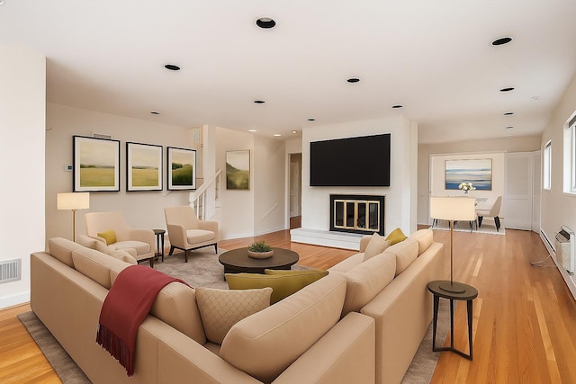 1901 New Hyde Park Rd, New Hyde Park, NY 11040 - living area featuring light wood-style floors, recessed lighting, and a glass covered fireplace