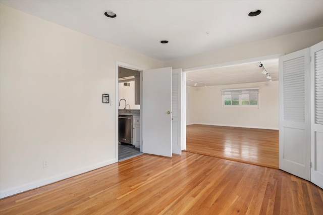 1901 New Hyde Park Rd, New Hyde Park, NY 11040 - spare room with light wood-type flooring and baseboards