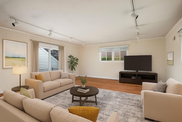 1901 New Hyde Park Rd, New Hyde Park, NY 11040 - living room featuring rail lighting, wood finished floors, and ornamental molding
