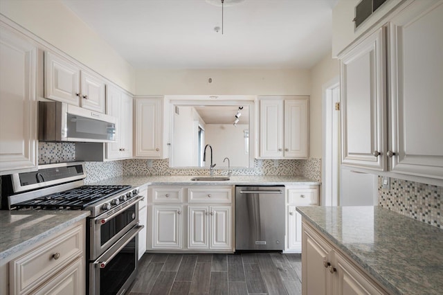 1901 New Hyde Park Rd, New Hyde Park, NY 11040 - kitchen featuring stainless steel appliances, decorative backsplash, light stone countertops, and white cabinets