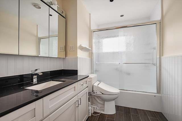 1901 New Hyde Park Rd, New Hyde Park, NY 11040 - bathroom featuring vanity, wood finish floors, wainscoting, and shower / bath combination with glass door