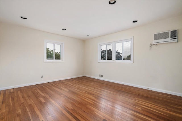 1901 New Hyde Park Rd, New Hyde Park, NY 11040 - unfurnished room featuring a wall unit AC, wood finished floors, and recessed lighting