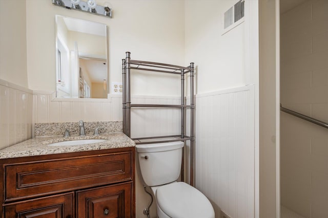 1901 New Hyde Park Rd, New Hyde Park, NY 11040 - full bathroom featuring wainscoting, vanity, and a tile shower