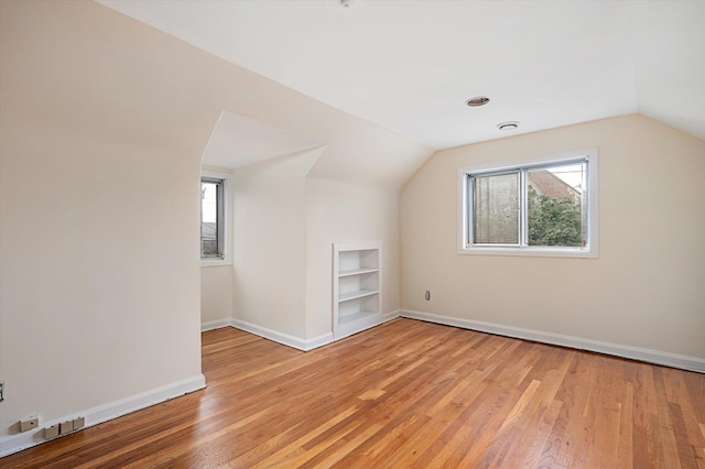 1901 New Hyde Park Rd, New Hyde Park, NY 11040 - additional living space with built in shelves, lofted ceiling, and light wood finished floors
