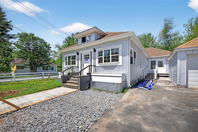 16 Broadway, Loch Sheldrake, NY 12759 - view of front facade featuring board and batten siding, roof with shingles, and driveway