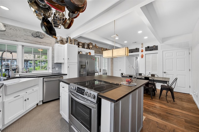 16 Broadway, Loch Sheldrake, NY 12759 - kitchen featuring appliances with stainless steel finishes, dark countertops, beamed ceiling, white cabinets, and recessed lighting