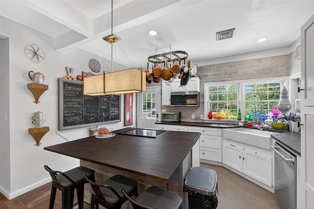 16 Broadway, Loch Sheldrake, NY 12759 - kitchen featuring appliances with stainless steel finishes, dark countertops, decorative backsplash, white cabinets, and recessed lighting