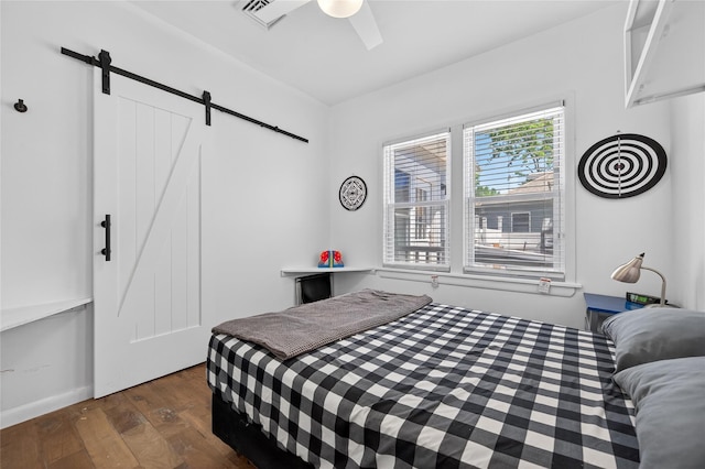 16 Broadway, Loch Sheldrake, NY 12759 - bedroom with a barn door, dark wood finished floors, and a ceiling fan
