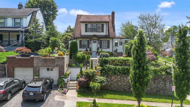 194 Valentine St, Yonkers, NY 10704 - dutch colonial with driveway, an attached garage, and a chimney