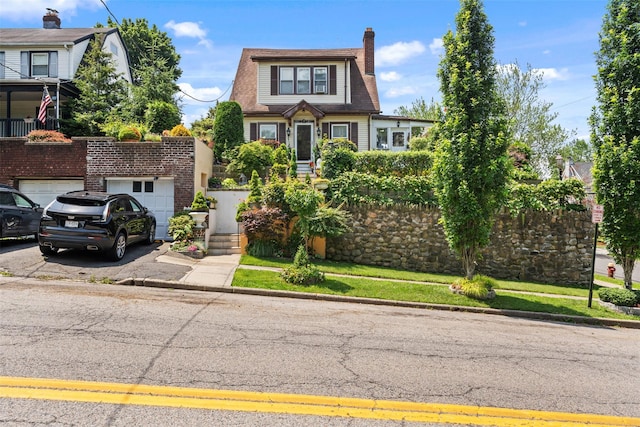 194 Valentine St, Yonkers, NY 10704 - view of front of property with asphalt driveway, a garage, and a chimney