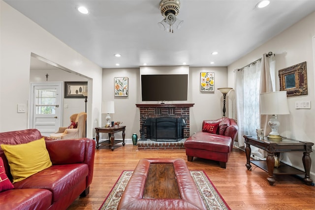 194 Valentine St, Yonkers, NY 10704 - living room featuring wood finished floors, recessed lighting, and a brick fireplace