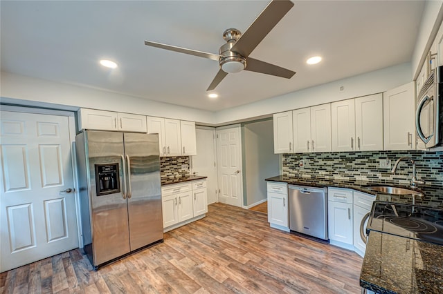 10 Valentine Rd, Shoreham, NY 11786 - kitchen featuring stainless steel appliances, a ceiling fan, backsplash, white cabinetry, and light wood finished floors