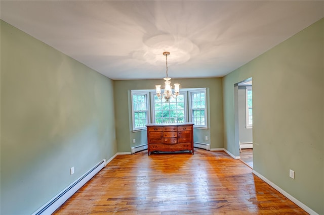 10 Valentine Rd, Shoreham, NY 11786 - spare room with a baseboard heating unit, a chandelier, and light wood finished floors