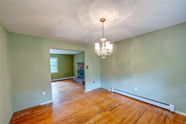 10 Valentine Rd, Shoreham, NY 11786 - unfurnished room with a baseboard radiator, light wood finished floors, and a chandelier