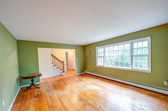 10 Valentine Rd, Shoreham, NY 11786 - unfurnished room with baseboard heating, wood-type flooring, and stairway