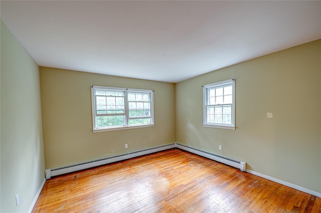 10 Valentine Rd, Shoreham, NY 11786 - unfurnished room featuring healthy amount of natural light, baseboard heating, and hardwood / wood-style floors