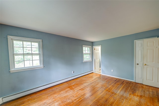 10 Valentine Rd, Shoreham, NY 11786 - unfurnished room with baseboard heating and hardwood / wood-style flooring