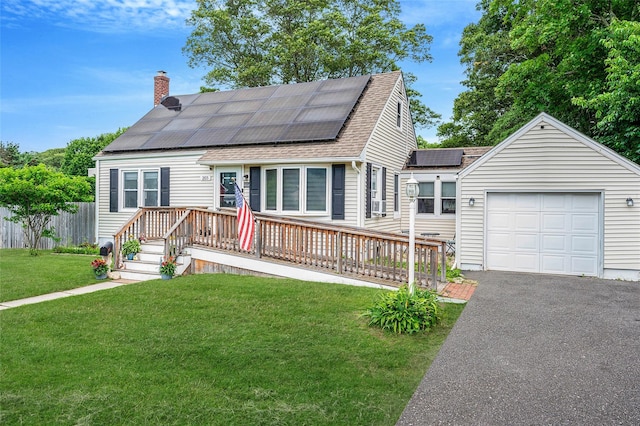 203 Lou Ave, Kings Park, NY 11754 - view of front facade with a chimney, a shingled roof, solar panels, driveway, and a wooden deck