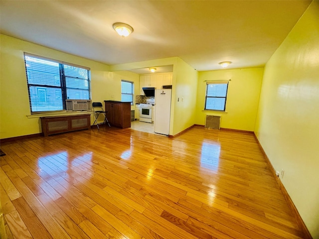 196-58 69th Ave Unit 1, Fresh Meadows, NY 11365 - unfurnished living room featuring light wood-style floors and cooling unit