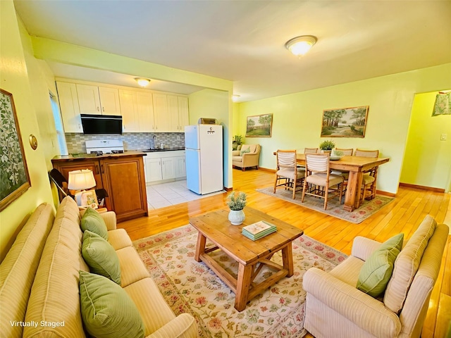 196-58 69th Ave Unit 1, Fresh Meadows, NY 11365 - living room with light wood-style floors and baseboards