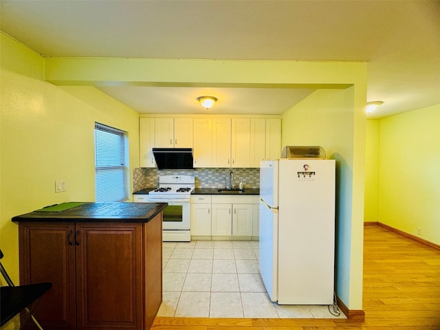 196-58 69th Ave Unit 1, Fresh Meadows, NY 11365 - kitchen with white appliances, dark countertops, ventilation hood, decorative backsplash, and white cabinets
