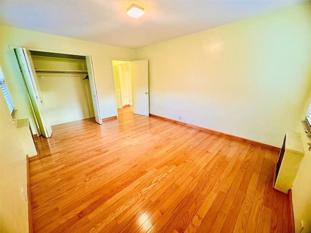 196-58 69th Ave Unit 1, Fresh Meadows, NY 11365 - unfurnished bedroom featuring light wood-style flooring and a closet