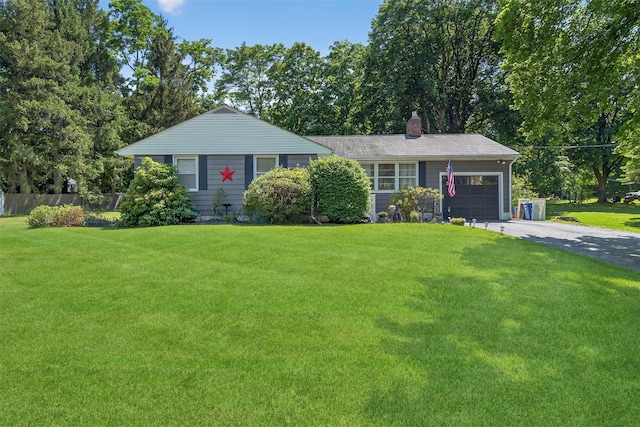 15 Cedar Ln, Cornwall, NY 12518 - ranch-style home featuring asphalt driveway, a garage, a chimney, and view of wooded area