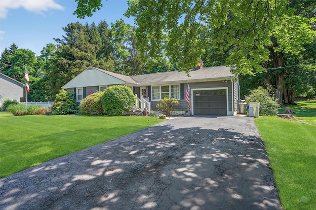 15 Cedar Ln, Cornwall, NY 12518 - single story home featuring asphalt driveway, a garage, a front lawn, and a chimney