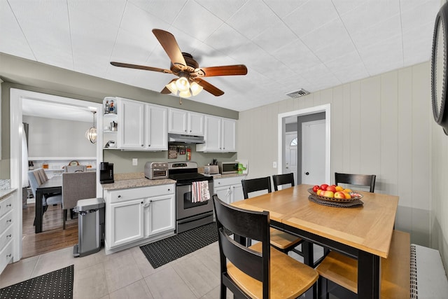 15 Cedar Ln, Cornwall, NY 12518 - kitchen with under cabinet range hood, stainless steel electric stove, white cabinetry, ceiling fan, and open shelves