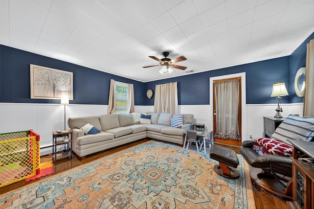 15 Cedar Ln, Cornwall, NY 12518 - living area featuring wood finished floors, wainscoting, a ceiling fan, and a baseboard heating unit