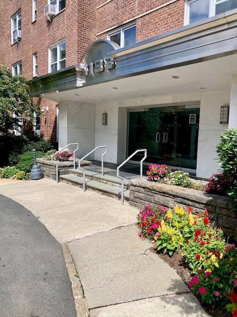 1133 Midland Ave Unit 3J, Bronxville, NY 10708 - doorway to property featuring brick siding and covered porch