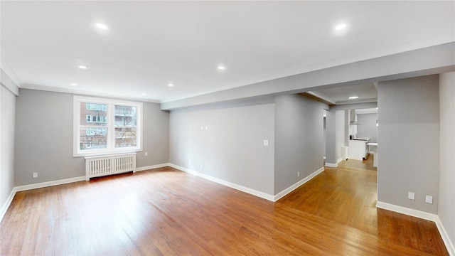 1133 Midland Ave Unit 3J, Bronxville, NY 10708 - unfurnished room featuring radiator heating unit, wood finished floors, ornamental molding, and recessed lighting