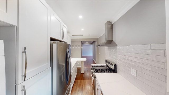 1133 Midland Ave Unit 3J, Bronxville, NY 10708 - kitchen featuring stainless steel appliances, wall chimney exhaust hood, white cabinetry, dark wood-type flooring, and ornamental molding
