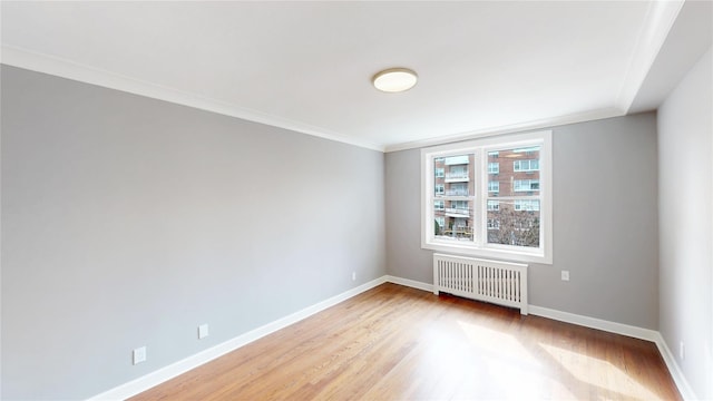 1133 Midland Ave Unit 3J, Bronxville, NY 10708 - spare room with radiator heating unit, light wood finished floors, and ornamental molding