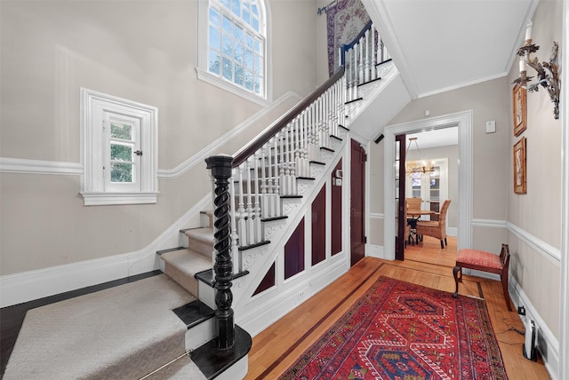 13 Garfield Pl, Poughkeepsie, NY 12601 - entryway with hardwood / wood-style flooring, stairway, a chandelier, crown molding, and a high ceiling
