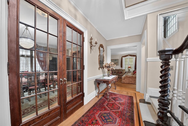13 Garfield Pl, Poughkeepsie, NY 12601 - foyer featuring wood finished floors, ornamental molding, french doors, and a wainscoted wall