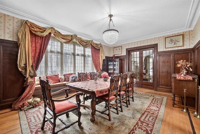 13 Garfield Pl, Poughkeepsie, NY 12601 - dining area featuring wallpapered walls, healthy amount of natural light, ornamental molding, light wood-style floors, and a wainscoted wall