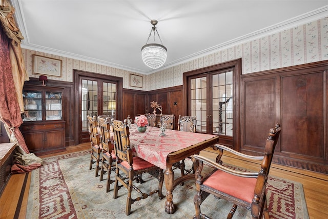 13 Garfield Pl, Poughkeepsie, NY 12601 - dining area featuring wallpapered walls, french doors, light wood-style floors, and crown molding