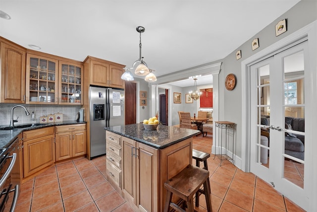13 Garfield Pl, Poughkeepsie, NY 12601 - kitchen with stainless steel appliances, light tile patterned flooring, french doors, backsplash, and glass insert cabinets