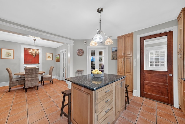 13 Garfield Pl, Poughkeepsie, NY 12601 - kitchen featuring light tile patterned floors, a breakfast bar, a center island, a chandelier, and hanging light fixtures
