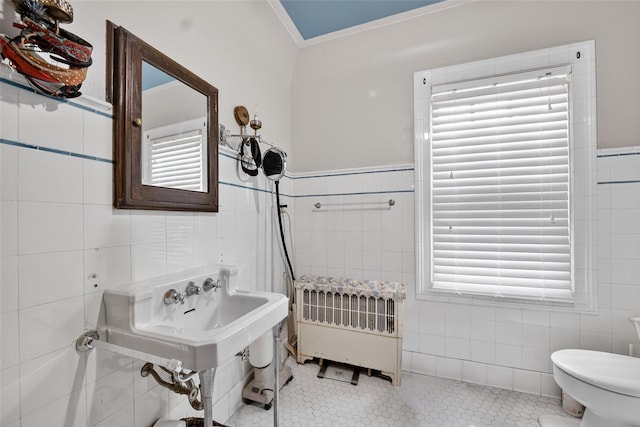13 Garfield Pl, Poughkeepsie, NY 12601 - half bath with tile walls, radiator heating unit, tile patterned flooring, ornamental molding, and wainscoting